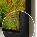 Close-up corner detail of a framed canvas with a black floating frame